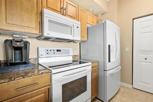 a kitchen with granite countertop a sink and a window