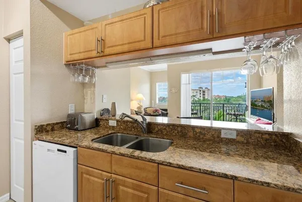 a kitchen with a sink and a stove top oven