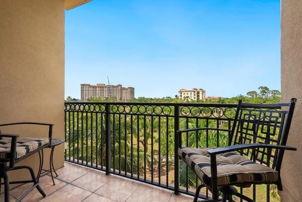 a view of a balcony with chairs