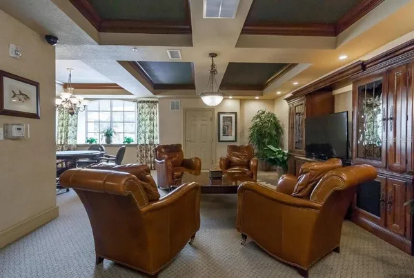 a room with pool table and windows