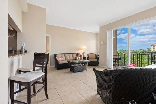 a living room with furniture a large window and a flat screen tv