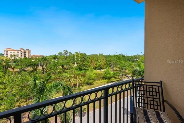 a living room with furniture and a dining table with kitchen view