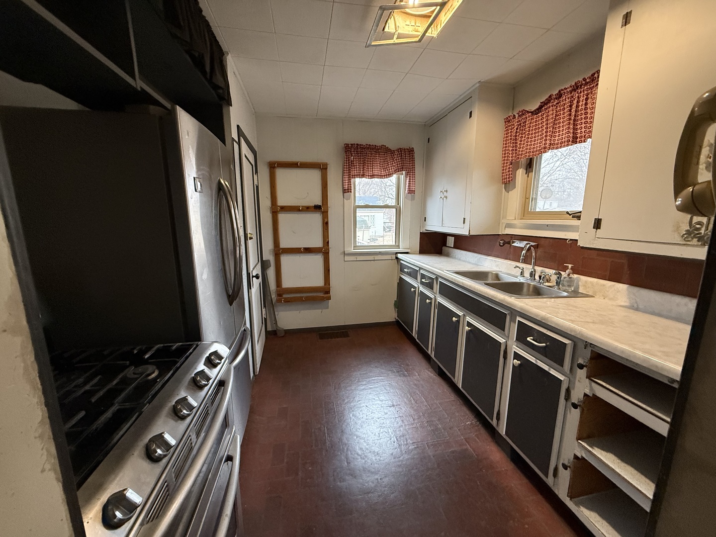 1849 Post Street Ottawa, IL 61350 - Photo 14 of 22 a kitchen with stainless steel appliances granite countertop a stove and a refrigerator