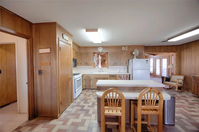 a large kitchen with a table and chairs