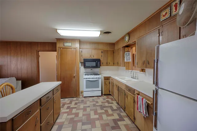 a open kitchen with stainless steel appliances granite countertop a refrigerator and a stove