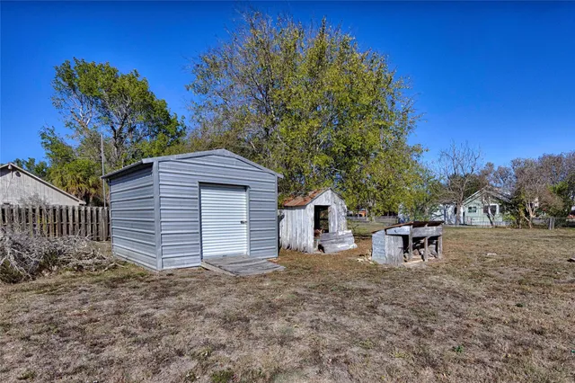 a view of a house with a yard and sitting area
