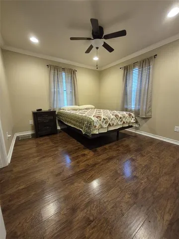 a spacious bedroom with a bed and a chandelier