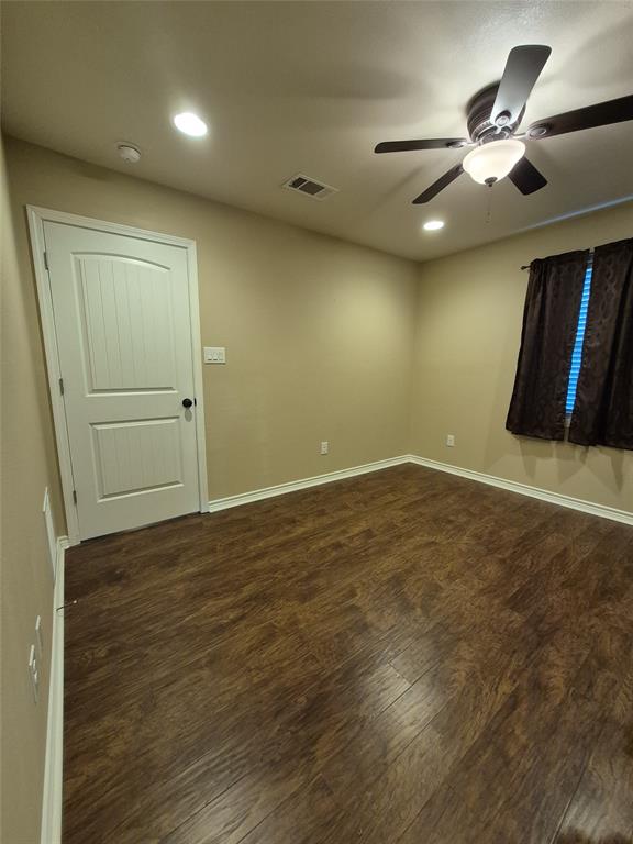 117 Maverick Trail Oak Point, TX 75068 - Photo 10 of 14 an empty room with wooden floor fan and windows