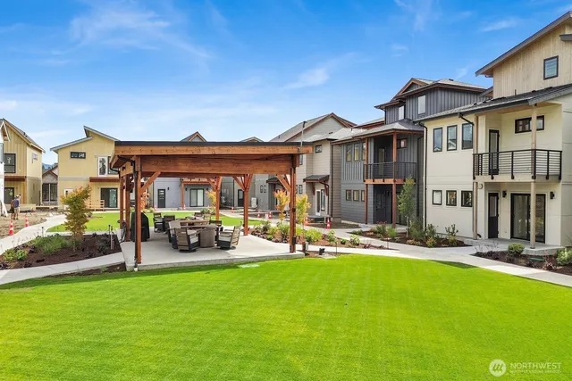 a view of a house with backyard porch and sitting area