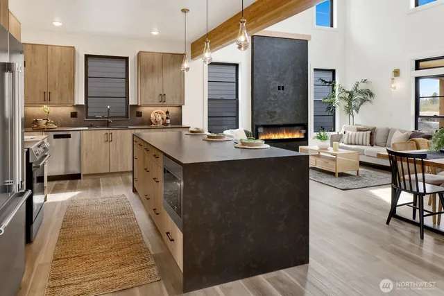 a kitchen with stainless steel appliances granite countertop a stove and a white cabinets