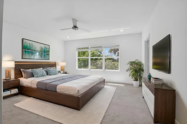 a bedroom with a large bed and a flat screen television