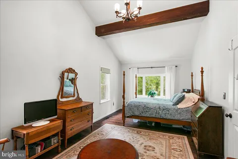 a bedroom with furniture and a window