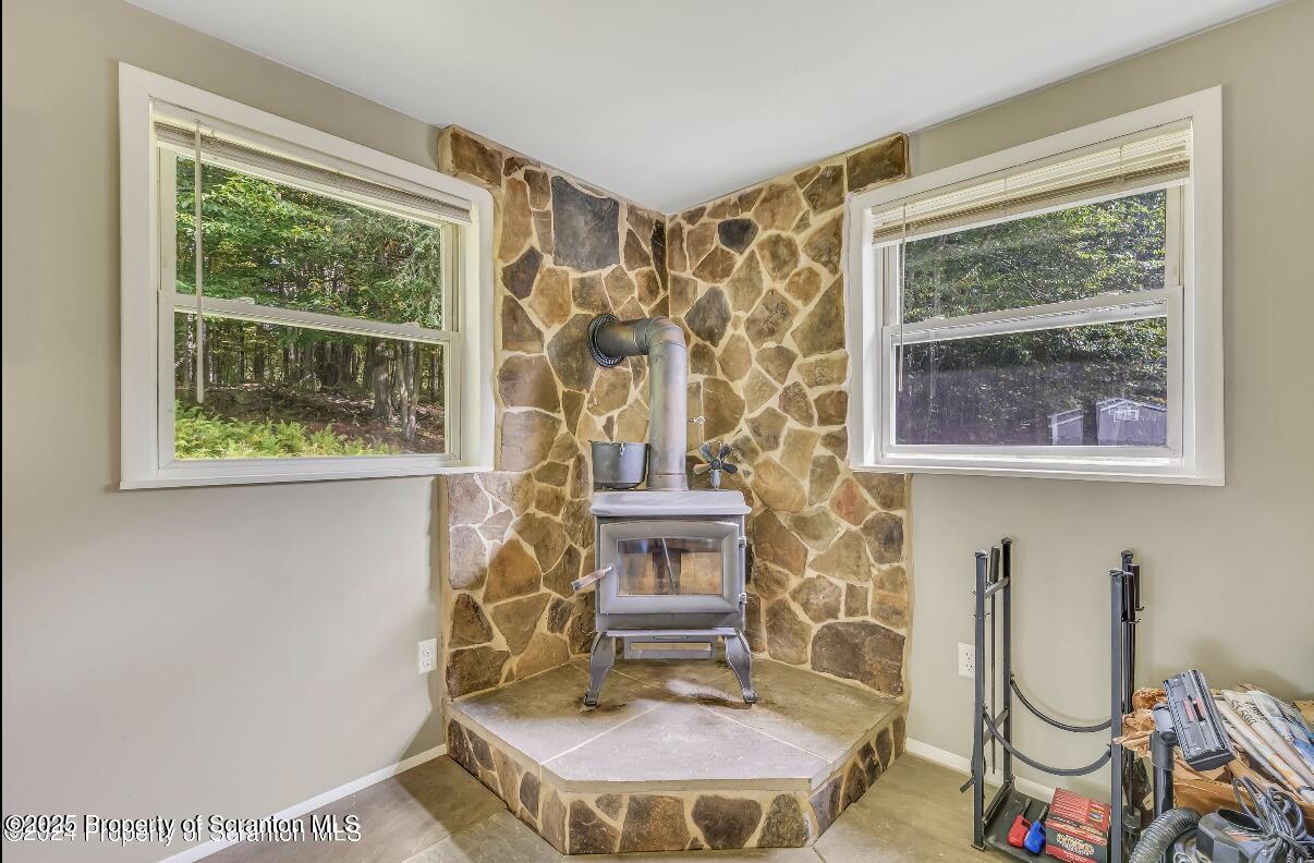 9311 Highway 3004 Springville, PA 18844 - Photo 14 of 51 a living room with fireplace furniture and a window