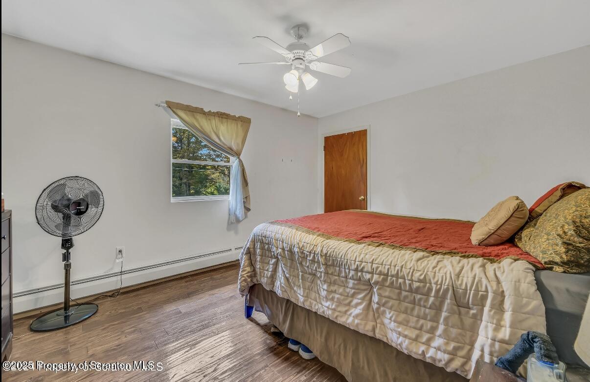 9311 Highway 3004 Springville, PA 18844 - Photo 26 of 51 a bedroom with a bed and a chandelier