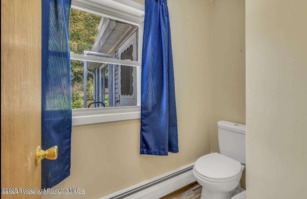 9311 Highway 3004 Springville, PA 18844 - Photo 32 of 51 a bathroom with a toilet sink and mirror
