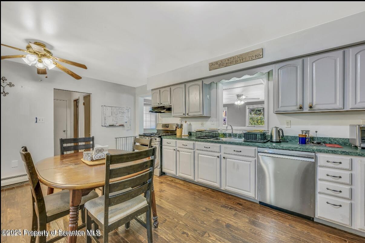 9311 Highway 3004 Springville, PA 18844 - Photo 9 of 51 a kitchen with stainless steel appliances granite countertop a stove a sink dishwasher and cabinets with wooden floor