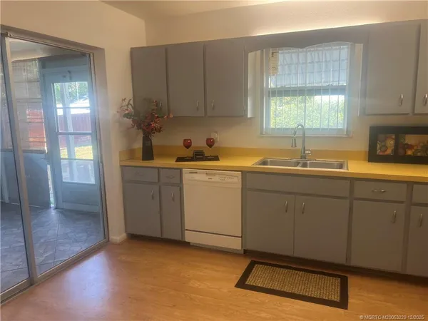 a kitchen with a sink cabinets and window