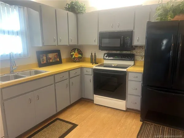 a kitchen with stainless steel appliances a stove a sink and a refrigerator