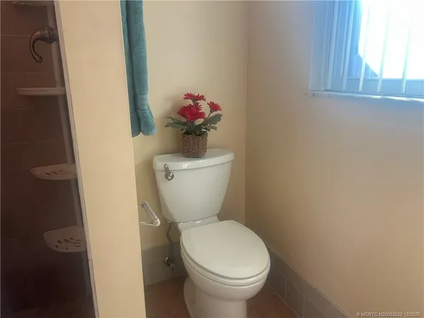 a bathroom with a sink toilet and mirror