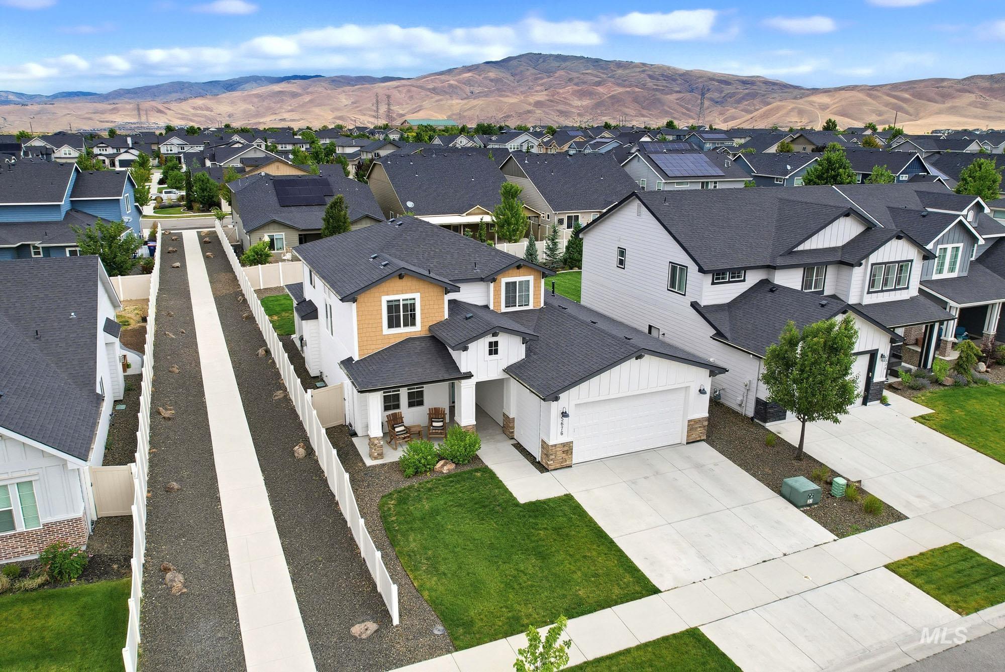 5676 East Zaffre Ridge Street Boise, ID 83716 - Photo 49 of 50 Two-story residence featuring a white and tan exterior with dark trim accents