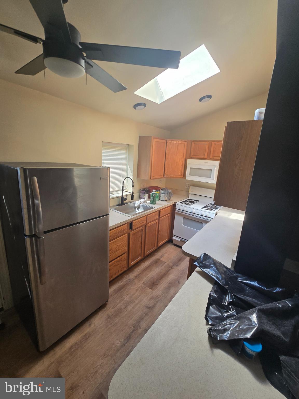 2118 Ruffner Street Philadelphia, PA 19140 - Photo 11 of 20 a kitchen with a refrigerator sink and cabinets