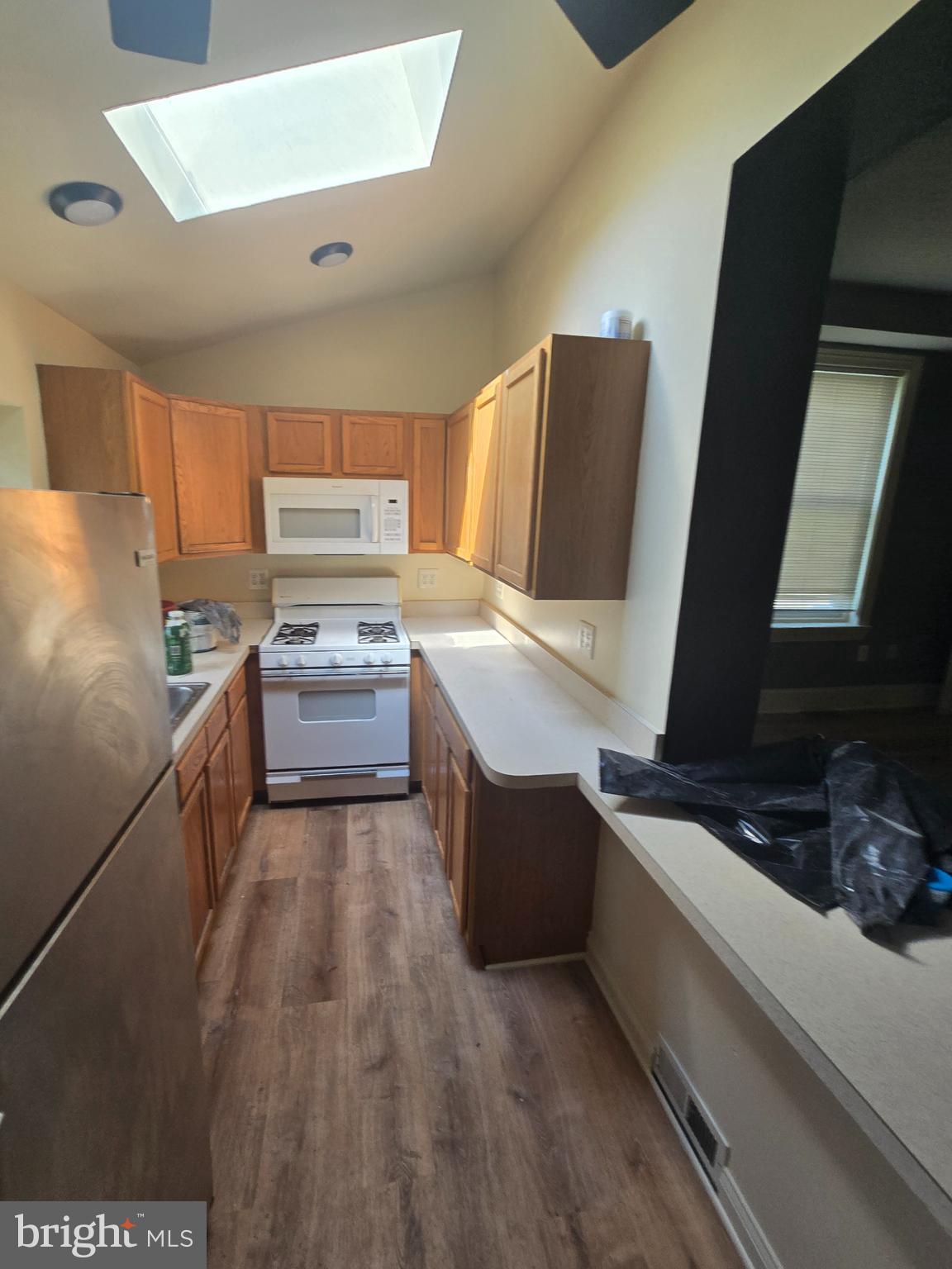 2118 Ruffner Street Philadelphia, PA 19140 - Photo 13 of 20 a kitchen with stainless steel appliances wooden cabinets and stove