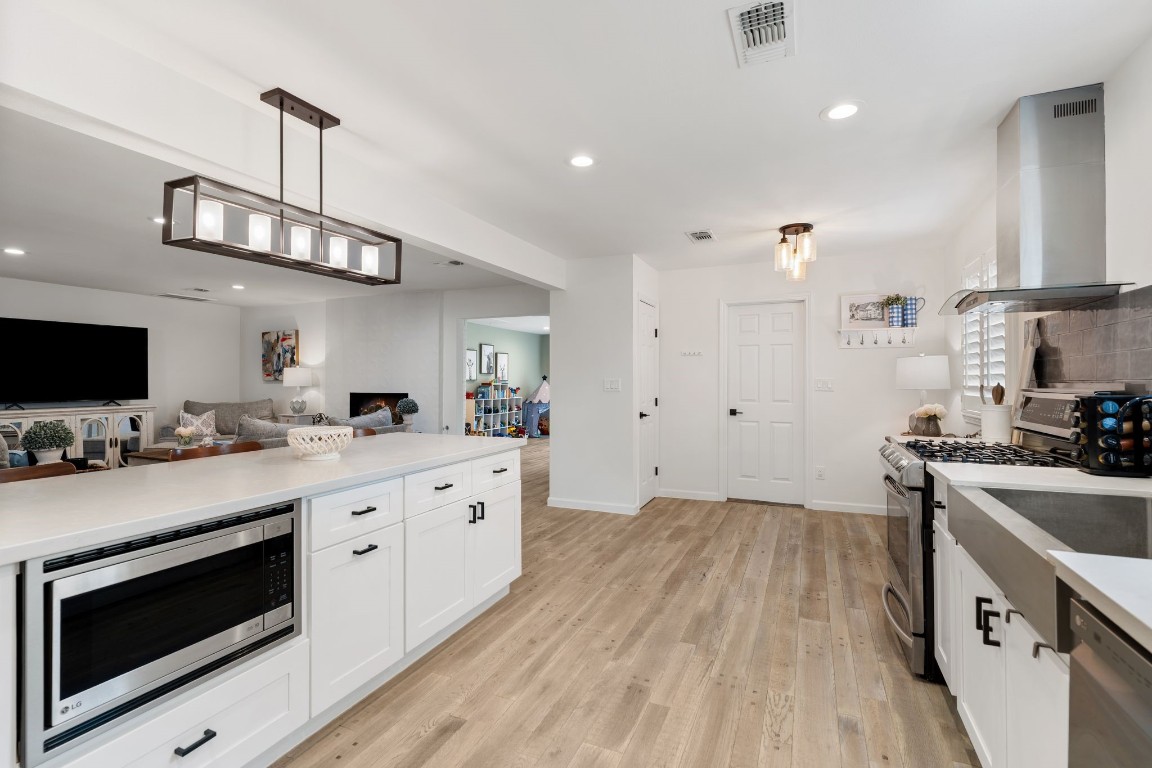 10619 Cranbrook Road Houston, TX 77042 - Photo 14 of 32 Crisp, white shaker-style cabinets create a clean and classic foundation, beautifully accented by sleek black hardware that adds a touch of contrast and sophistication.