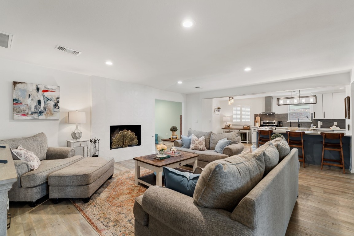 10619 Cranbrook Road Houston, TX 77042 - Photo 10 of 32 Anchored by a cozy fireplace, this bright and airy space seamlessly connects to the kitchen, creating an effortless flow.