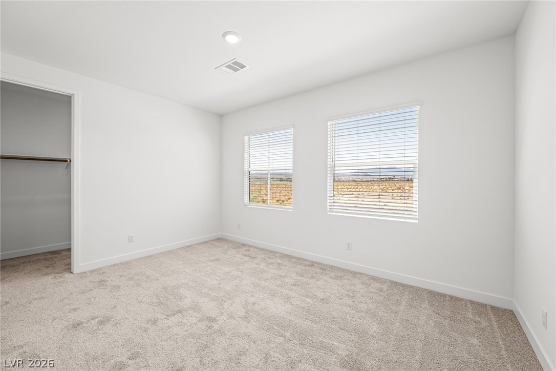9983 Decano Ridge Street Las Vegas, NV 89141 - Photo 30 of 39 A quiet bedroom offering expansive views through its pair of windows.