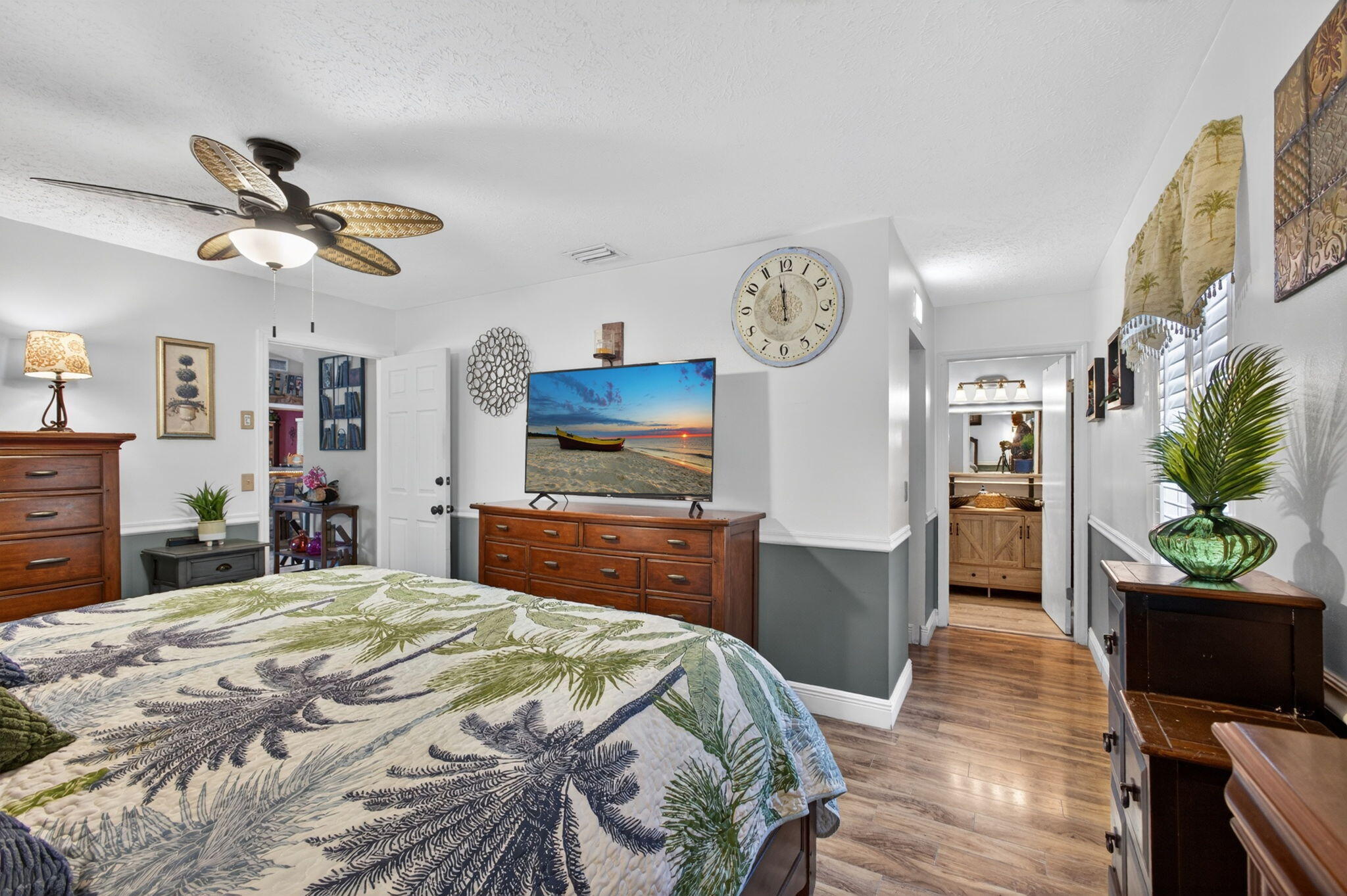 12558 165th Road North Jupiter, FL 33478 - Photo 27 of 67 a bedroom with a bed and a chandelier