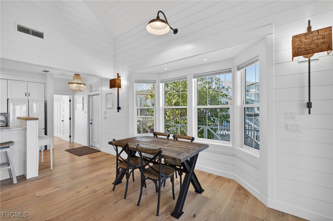 520 Useppa Island Bokeelia, FL 33922 - Photo 14 of 47 a view of a dining room with furniture window and wooden floor