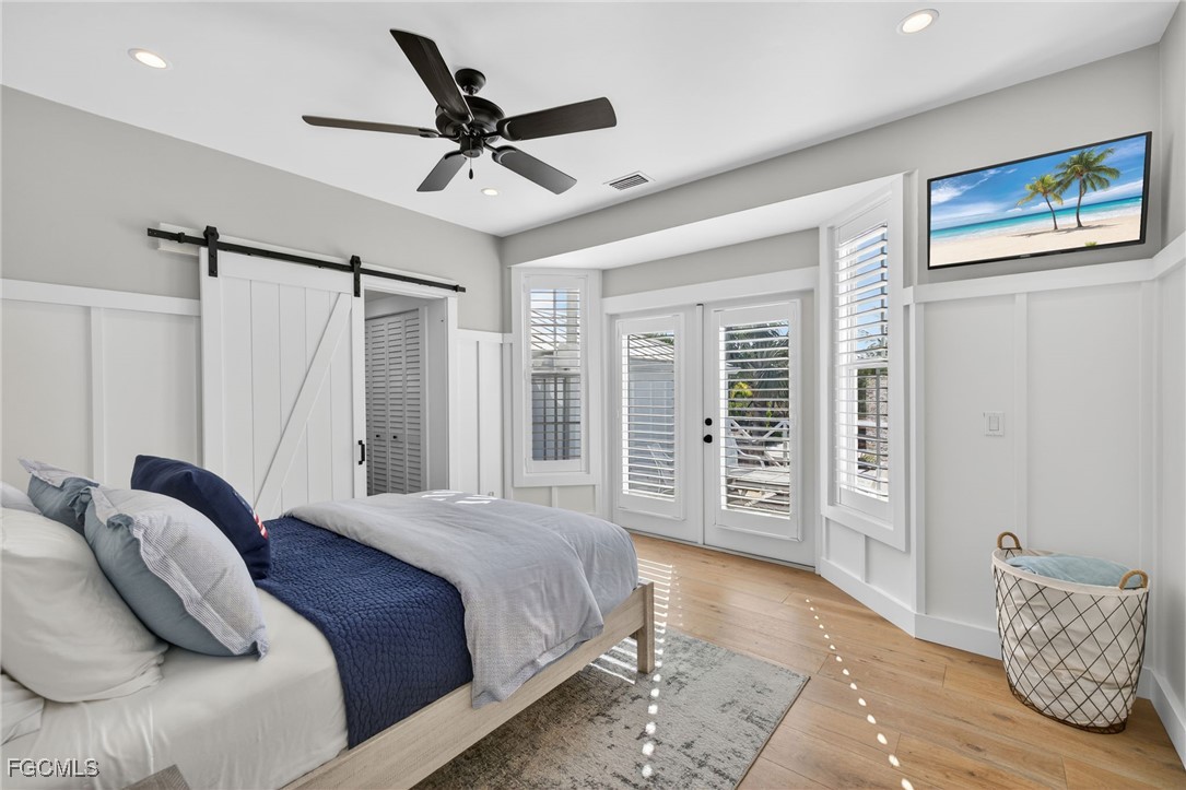 520 Useppa Island Bokeelia, FL 33922 - Photo 20 of 47 a bedroom with a large bed and a chandelier