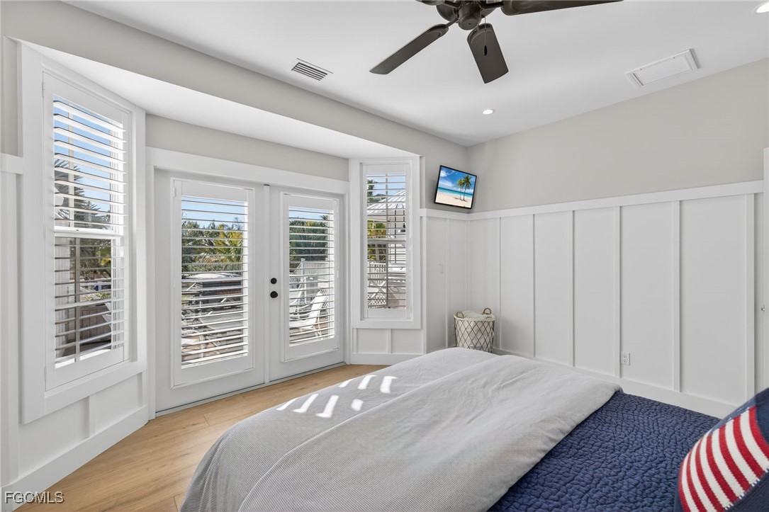 520 Useppa Island Bokeelia, FL 33922 - Photo 22 of 47 a bedroom with a large bed and wooden floor