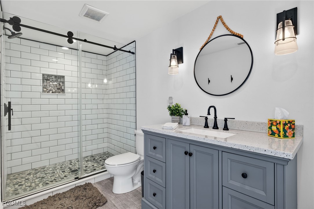 520 Useppa Island Bokeelia, FL 33922 - Photo 24 of 47 a bathroom with a granite countertop sink a toilet and a mirror