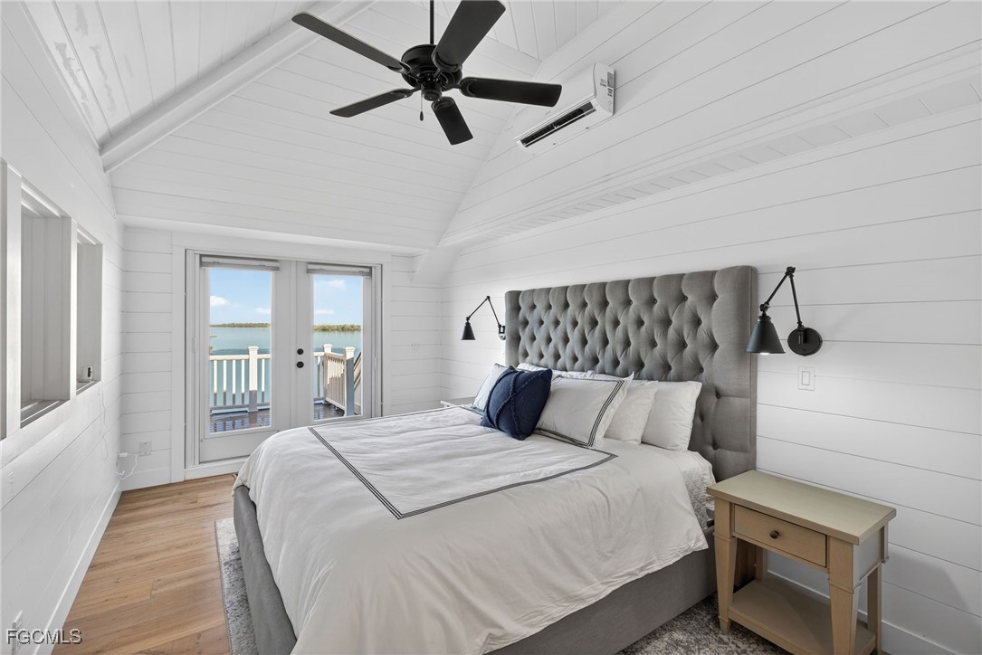 520 Useppa Island Bokeelia, FL 33922 - Photo 25 of 47 a bedroom with a large bed and a chandelier