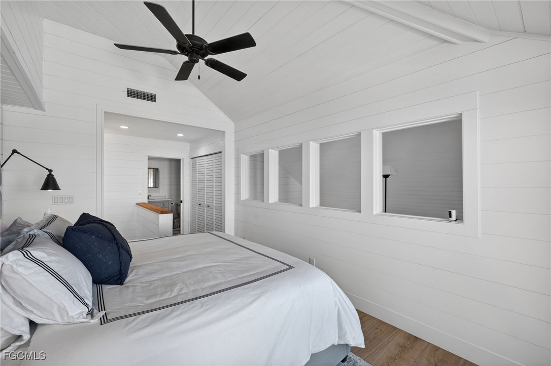 520 Useppa Island Bokeelia, FL 33922 - Photo 27 of 47 a bedroom with a large bed and a chandelier