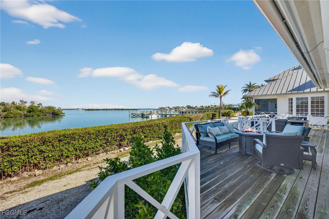 520 Useppa Island Bokeelia, FL 33922 - Photo 34 of 47 a view of a balcony with wooden floor and outdoor space