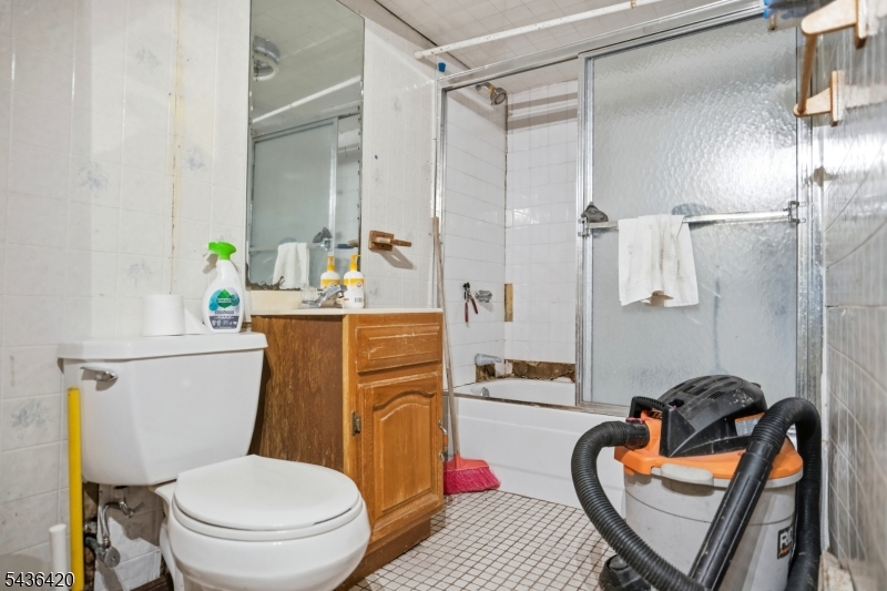33 Pulaski Place Hackensack, NJ 07601 - Photo 28 of 31 a bathroom with a toilet a sink and a shower