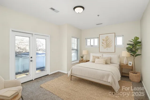 a bedroom with a large bed and a couch