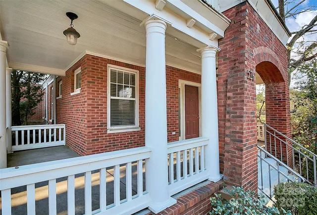 a view of a brick house with a porch