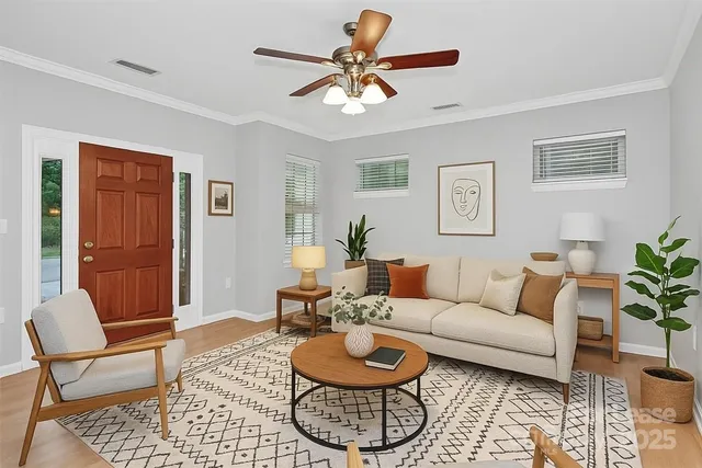 a living room with furniture a rug and a window
