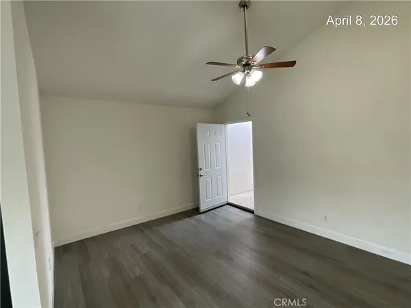 a view of a chandelier fan and wooden floor