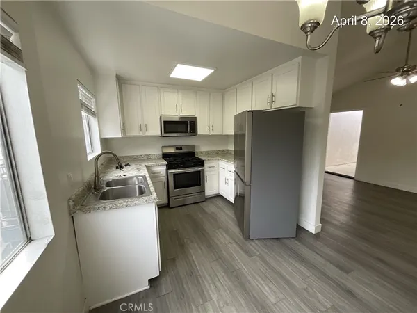 a kitchen with a refrigerator a stove top oven a sink and dishwasher