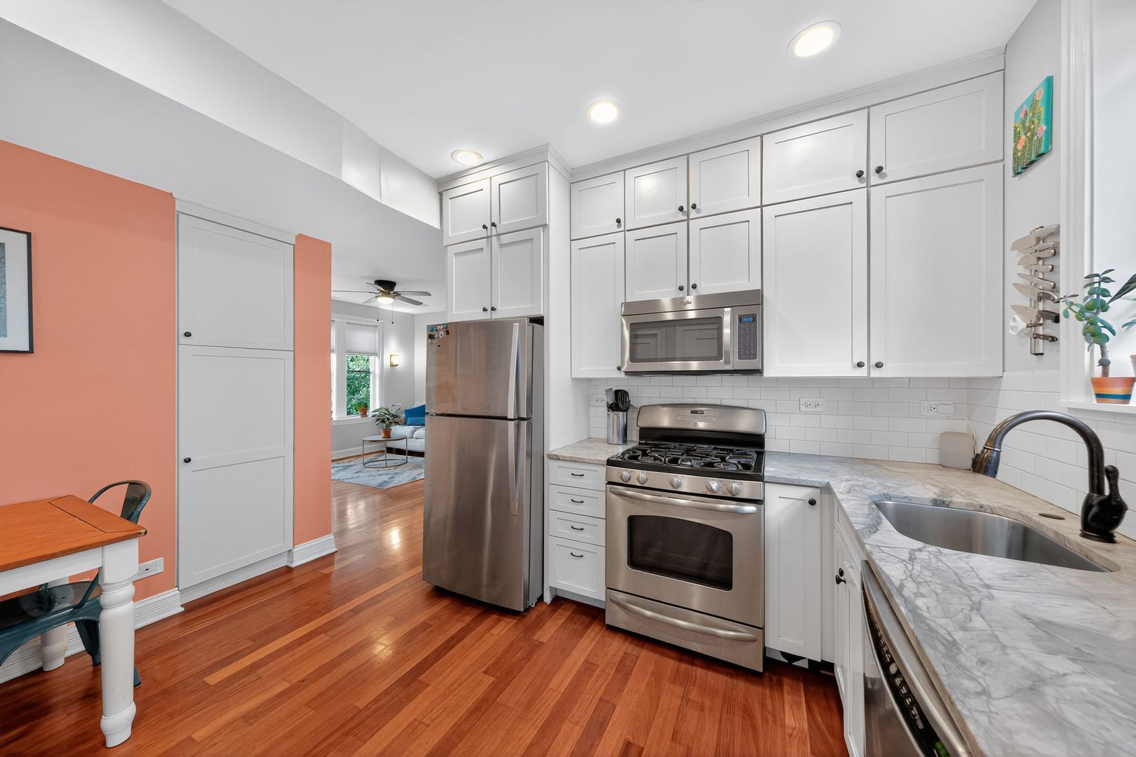 2578 West Lyndale Street, Unit 2 Chicago, IL 60647 - Photo 5 of 17 a kitchen with granite countertop a refrigerator stove and sink