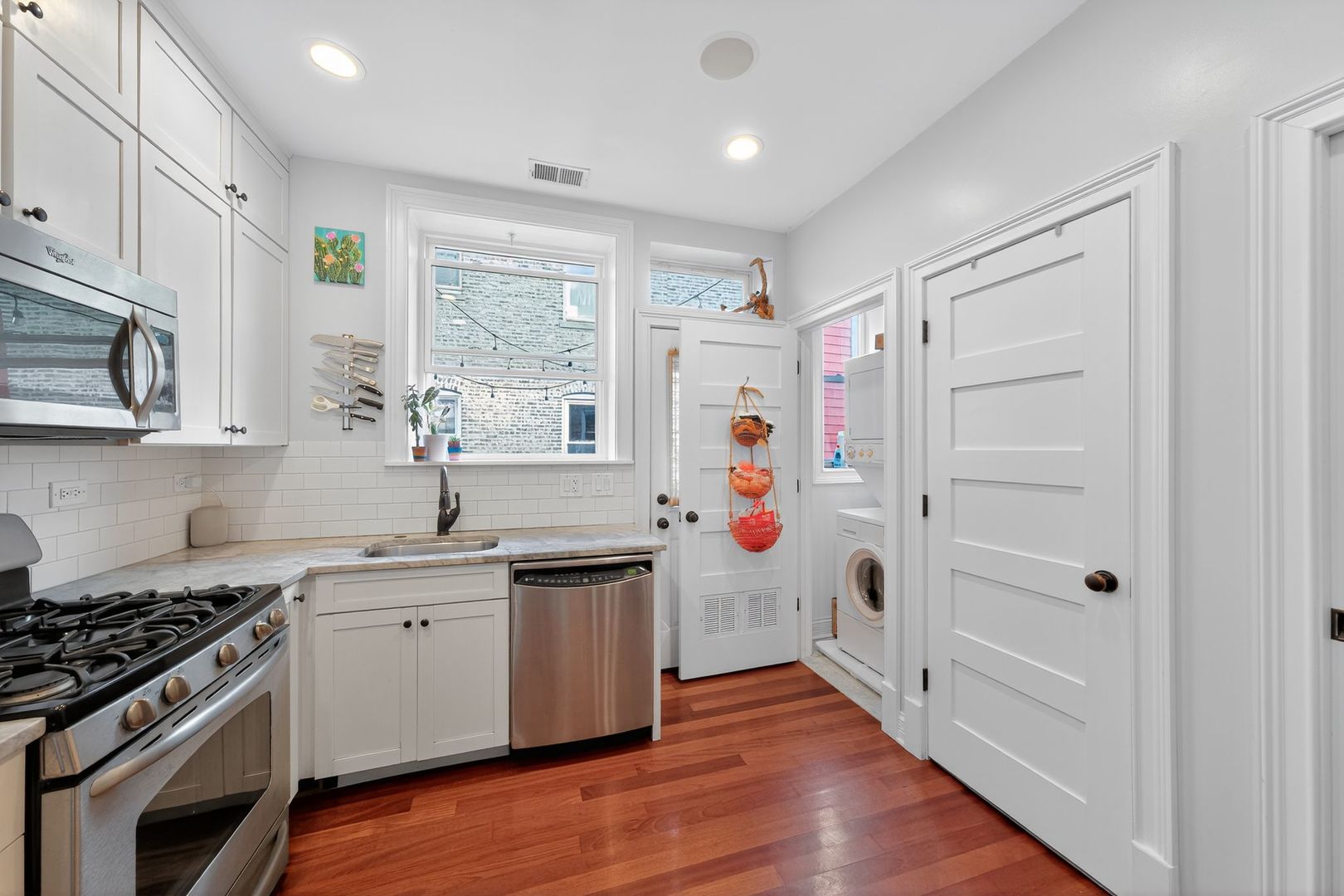 2578 West Lyndale Street, Unit 2 Chicago, IL 60647 - Photo 7 of 17 a kitchen with stainless steel appliances a stove a sink and a refrigerator