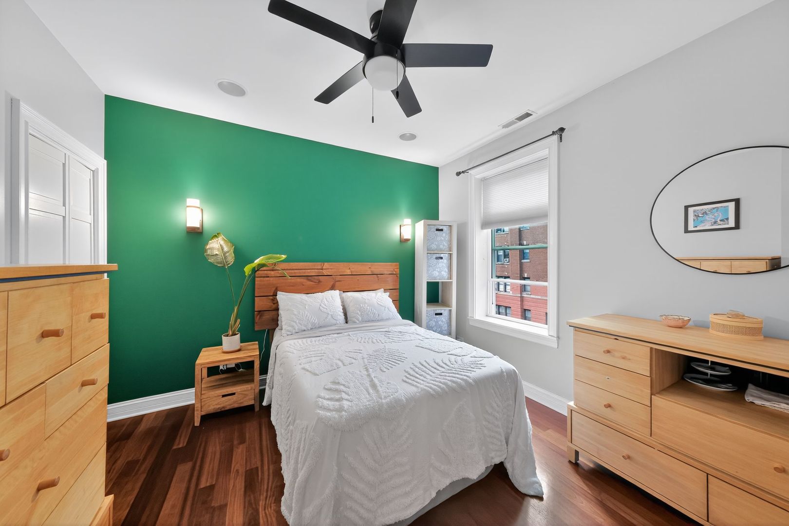 2578 West Lyndale Street, Unit 2 Chicago, IL 60647 - Photo 10 of 17 a bedroom with a bed and a chandelier