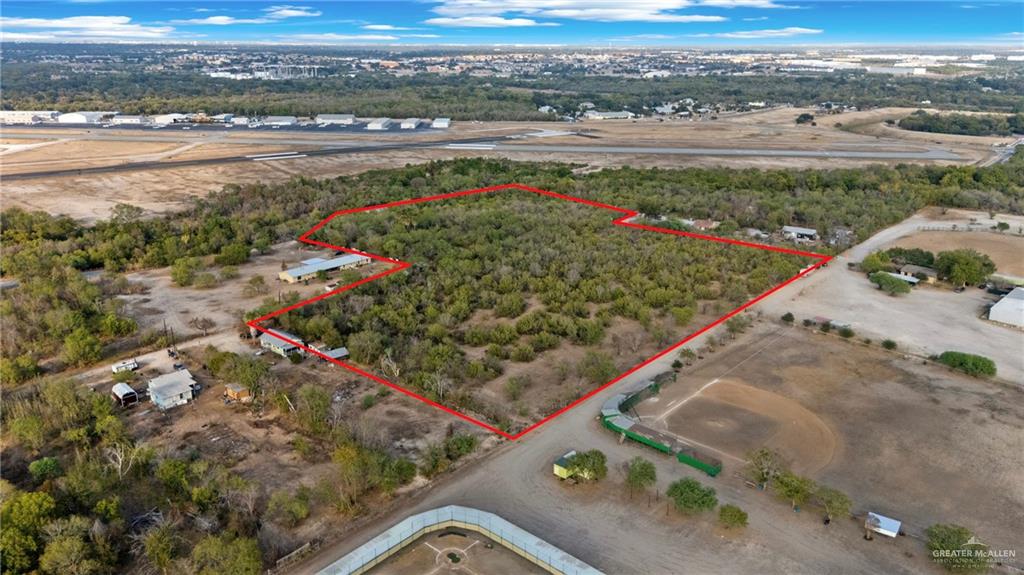 1706 East Ashley Road San Antonio, TX 78214 - Photo 7 of 16 Expansive wooded acreage outlined in red, featuring several structures including a primary residence, outbuildings, and a large workshop or commercial building