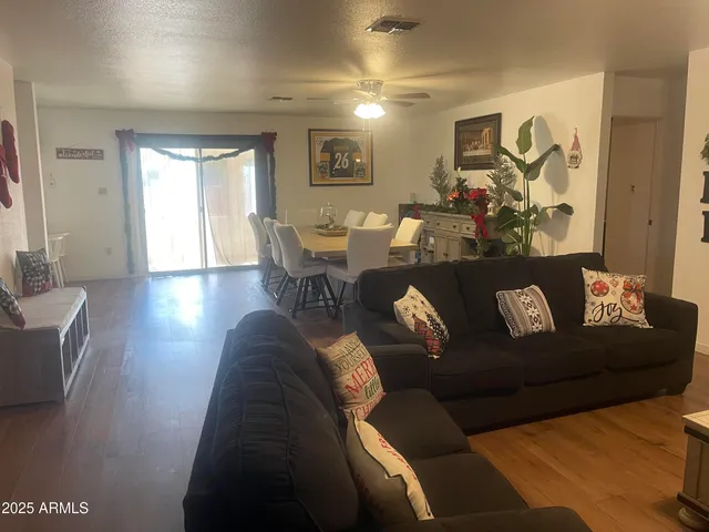 a living room with furniture and a wooden floor