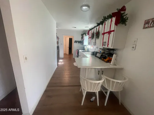 a dining room with furniture and wooden floor