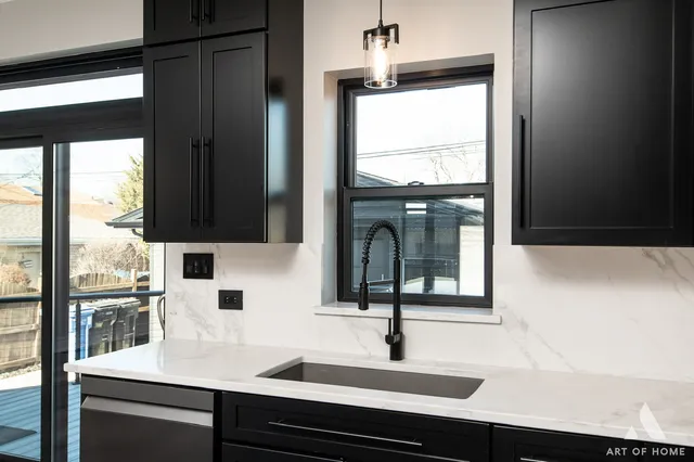 a view of a living room with wooden floor and a kitchen